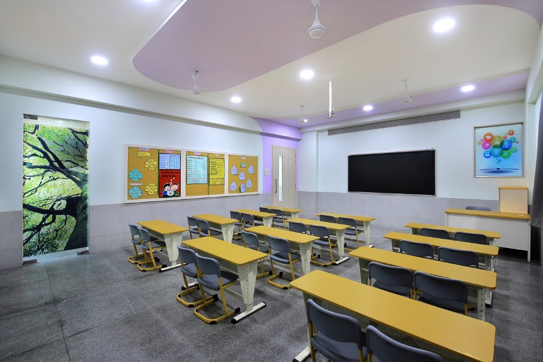 Vibgyor High School classroom with rows of desks and chairs facing a blackboard